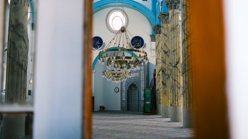 Free Intricate chandeliers and marble columns inside Hayrettin Pasha Mosque, Ayvalik, reflecting sacred architecture. Stock Photo