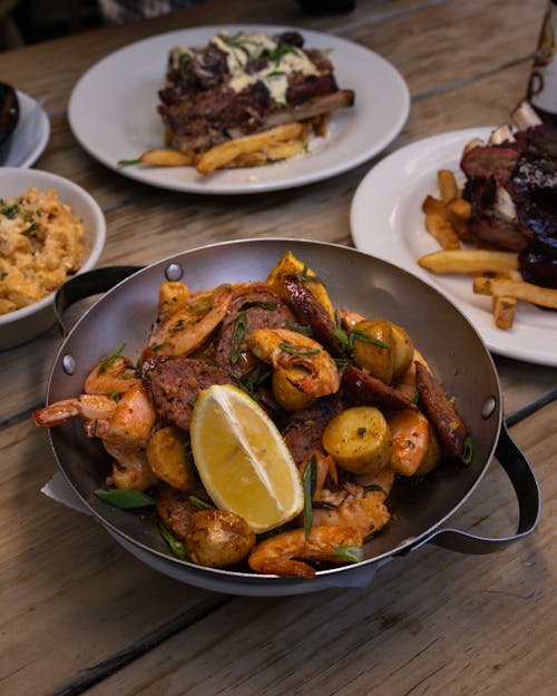 A plate of food with fries and a bowl of meat