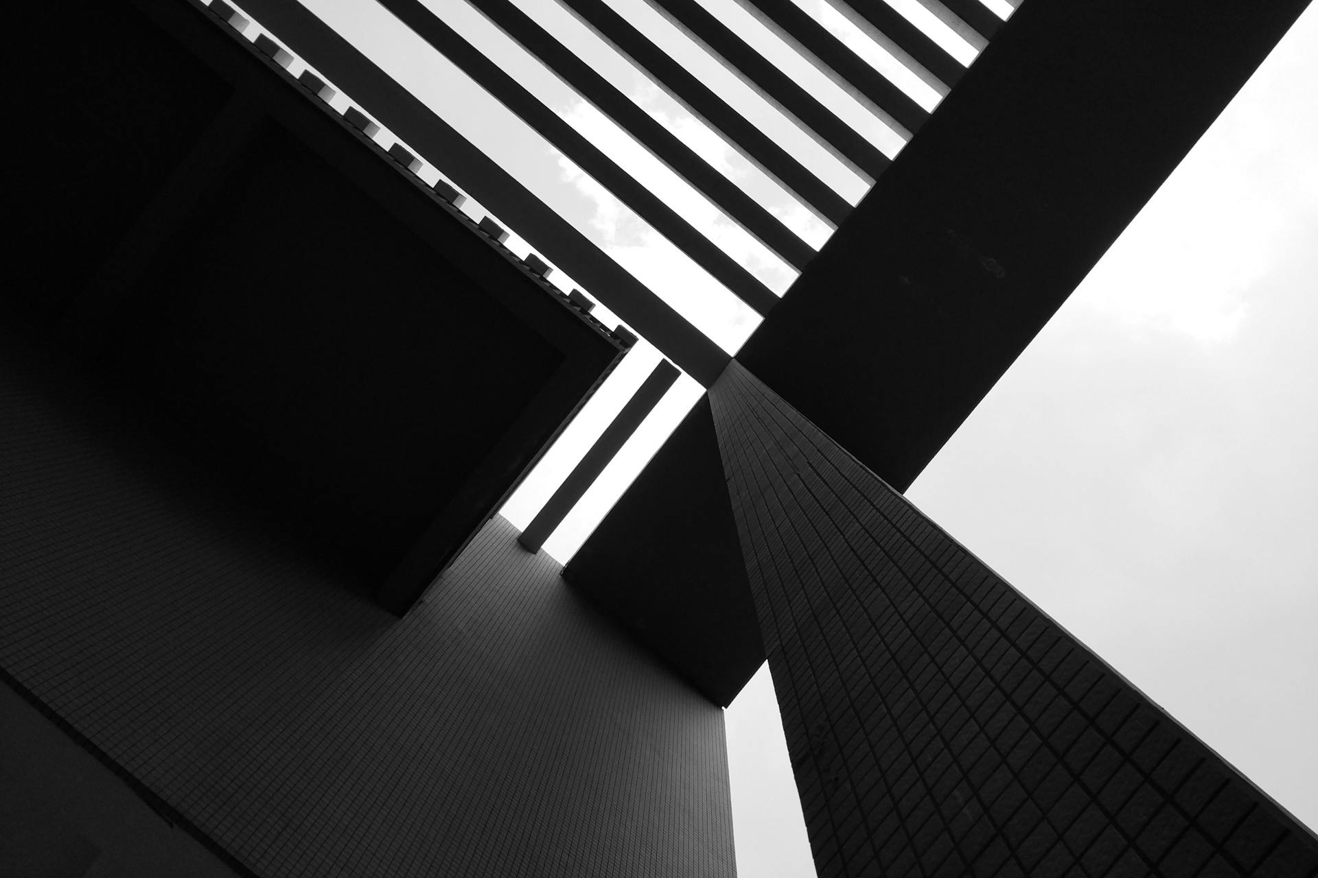 Black and white abstract view of modern architecture with geometric lines and perspective.