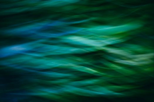 Ethereal image with vibrant abstract green and blue waves, creating a soothing flow.