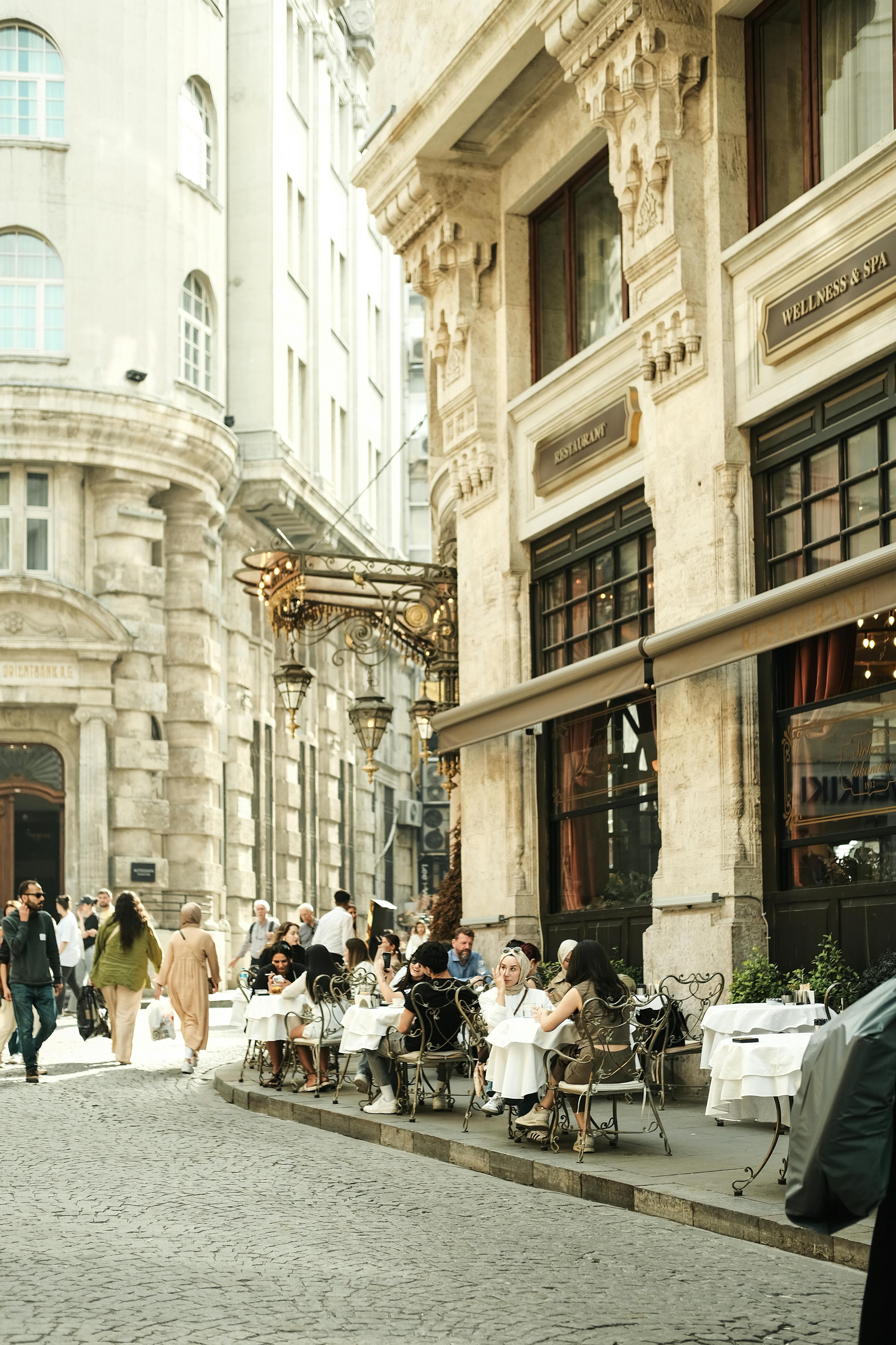 Outdoor cafe scene in Istanbul with people enjoying the historic city streets.