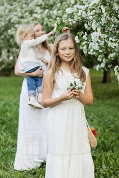 在盛开的果园里，一位母亲和她的女儿们享受着宁静的时刻，捕捉着家庭的团聚与欢乐