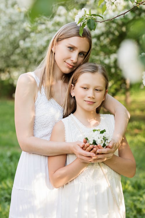 Woman and Girl Holding Bouquet