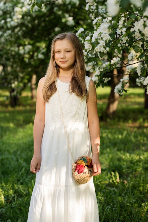 Chica Con Vestido Blanco Sin Mangas De Pie Y Sonriendo En Campo Abierto Verde