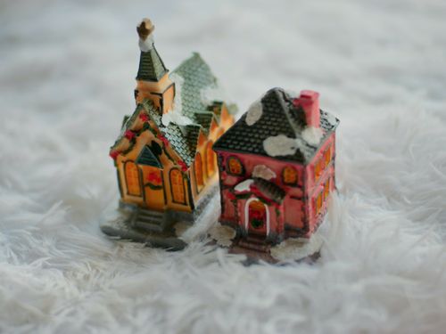 Free Charming miniature snow-covered houses in a Christmas village scene with soft focus. Stock Photo