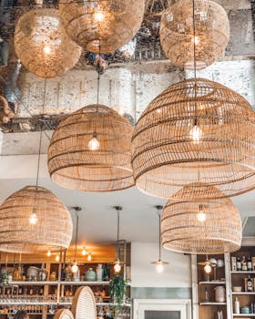 Stylish wicker pendant lights enhancing the ambiance of a modern French café in Alfortville, France.
