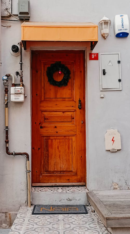 A wooden door with a wreath on it