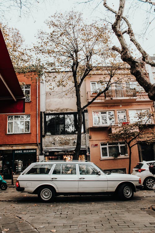 A white car parked on the side of a street