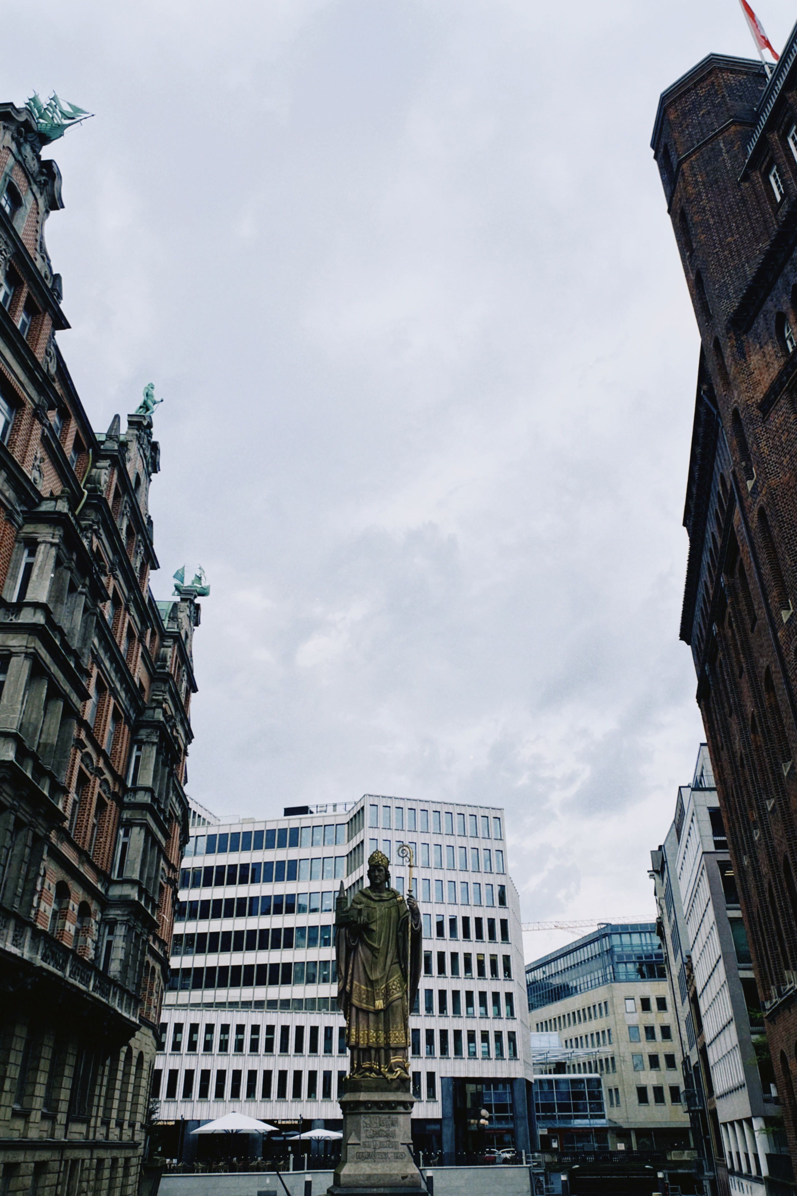 A captivating view of a statue surrounded by historic buildings in Hamburg, Germany.