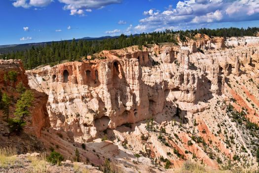 Explore the breathtaking sandstone formations in Bryce Canyon under a bright sky.