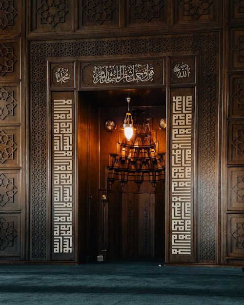 A door with intricate carvings in the middle of a room