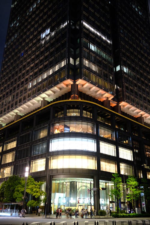 A large building with a glass front at night