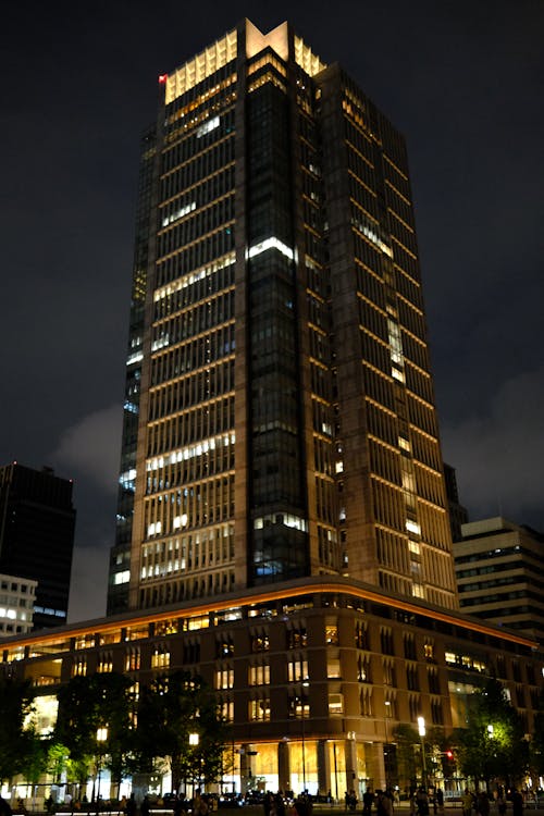 A tall building with lights on at night