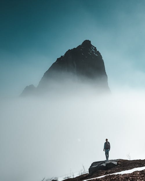 Free Man Looking At A Rock Formation Stock Photo