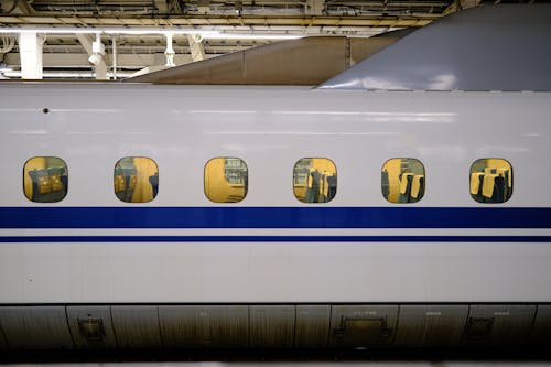 A white bullet train with windows in the middle