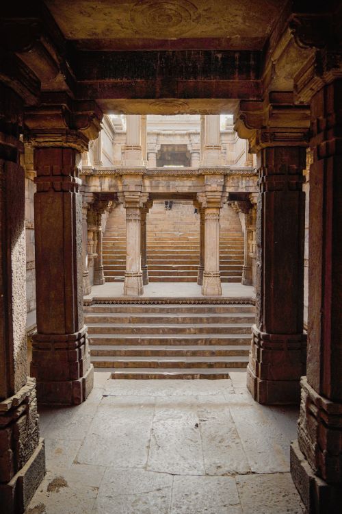 Free Explore the ancient stepwell's intricate architecture in Ahmedabad, India, with detailed stone carvings and columns. Stock Photo