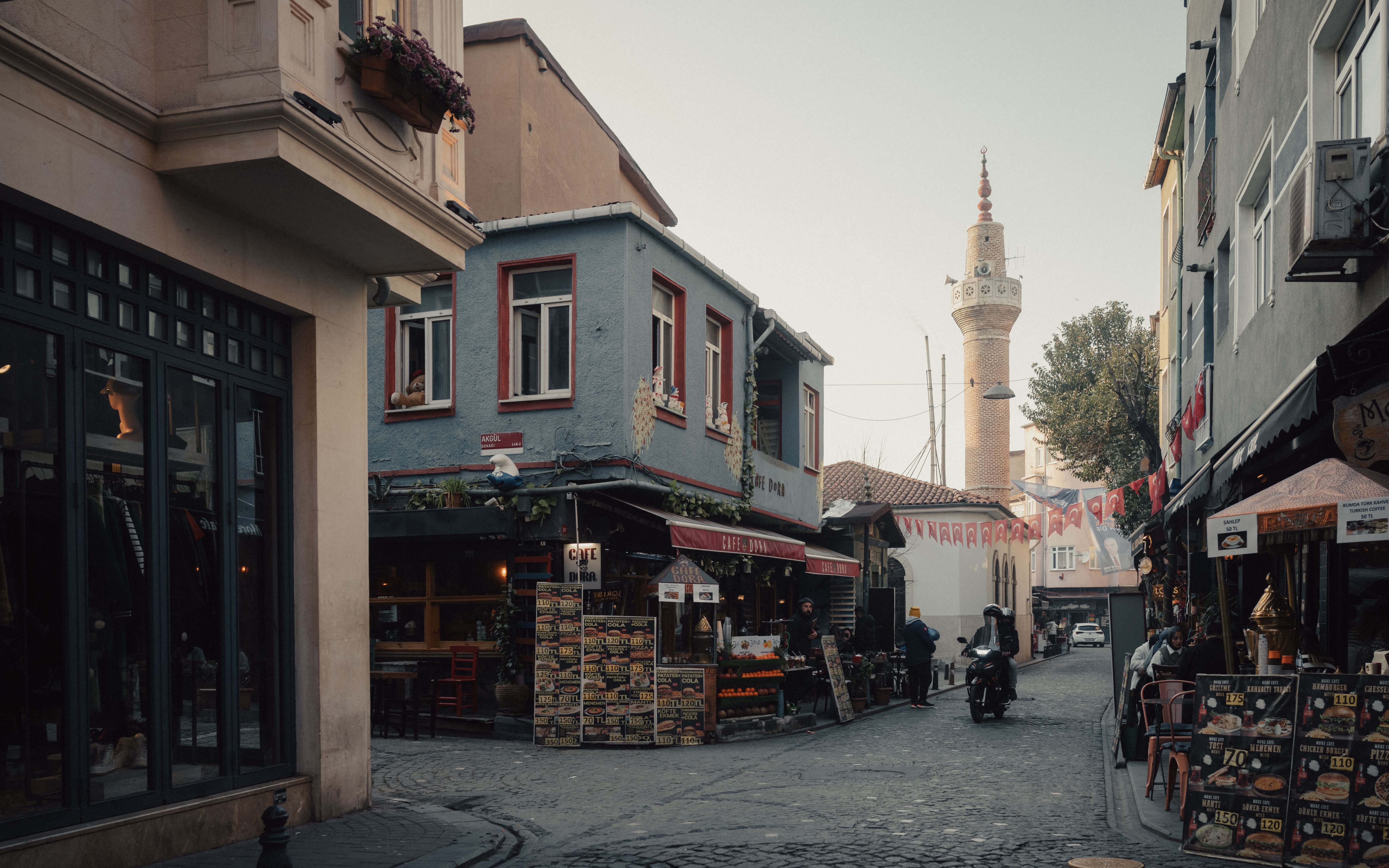 Charming street in Fener, Istanbul featuring old architecture and a mosque in the background.