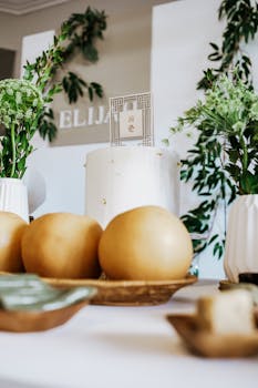 White cake at a Korean Dohl celebration with fruits and plants.