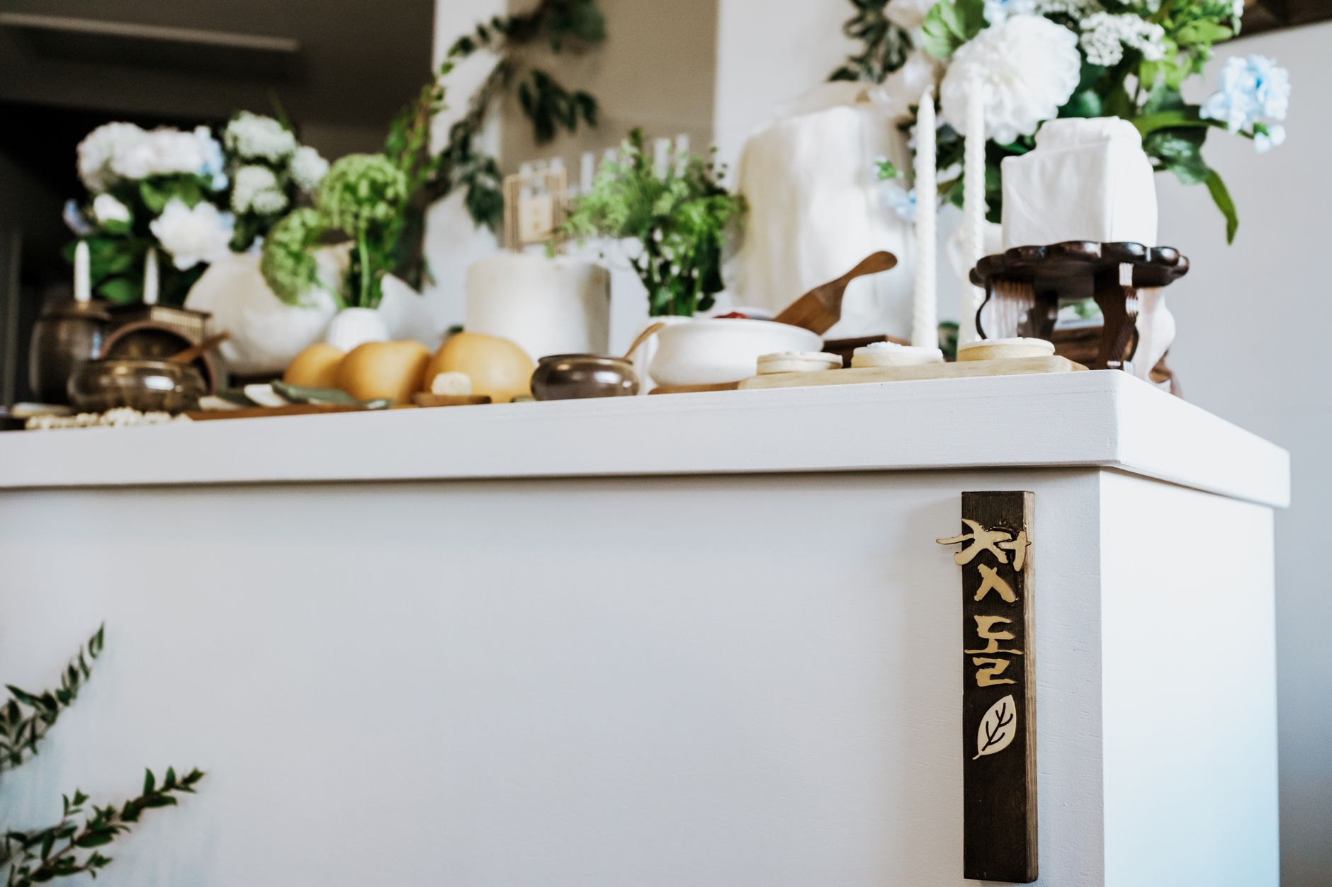 Decorative Korean table setup with floral arrangements and traditional items, perfect for cultural celebrations.