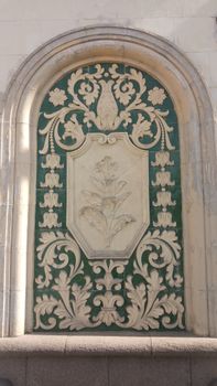 Detailed exterior wall relief with floral motifs in Kyiv, Ukraine.