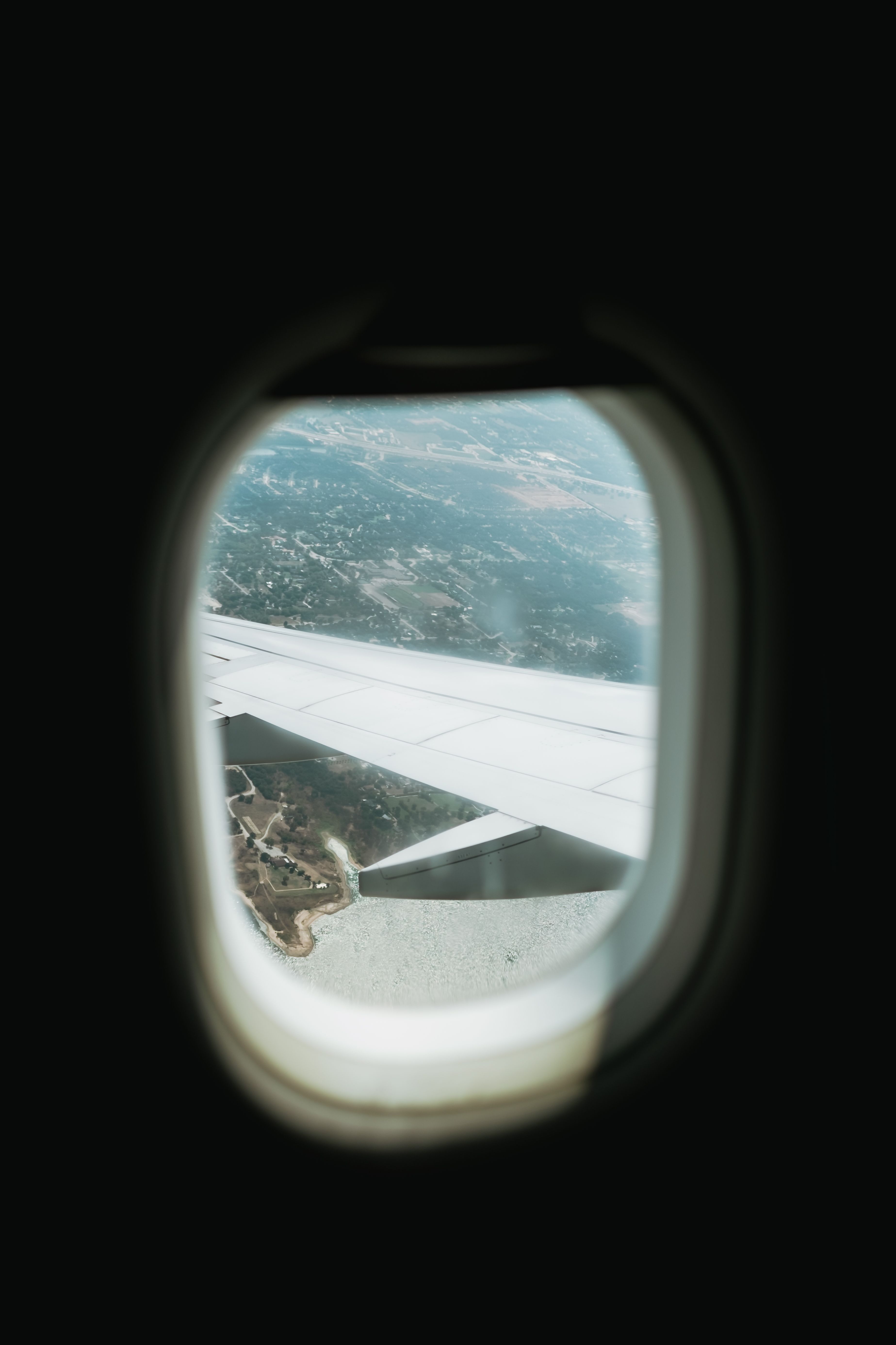 Wing of Flying Airplane behind Window · Free Stock Photo