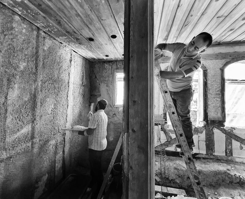 Home renovation project with workers renovating a living room