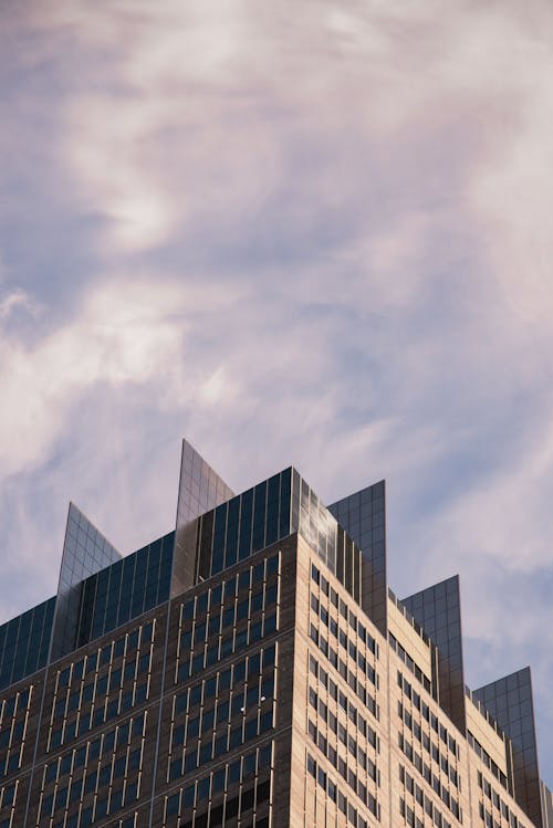 Low Angle Photography Of High-rise Building Under Cloudy Sky