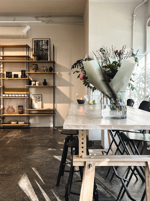 A table with flowers and a vase on it