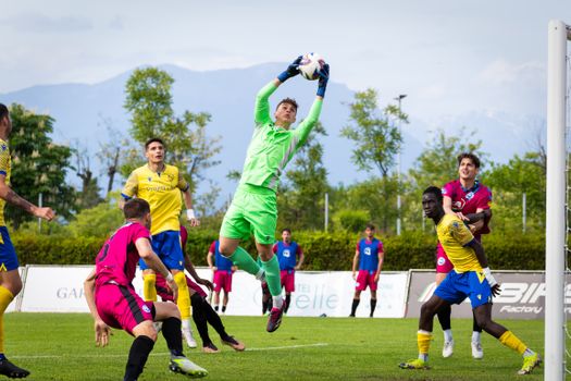 Goalkeeper in action during an intense soccer match with diverse players.