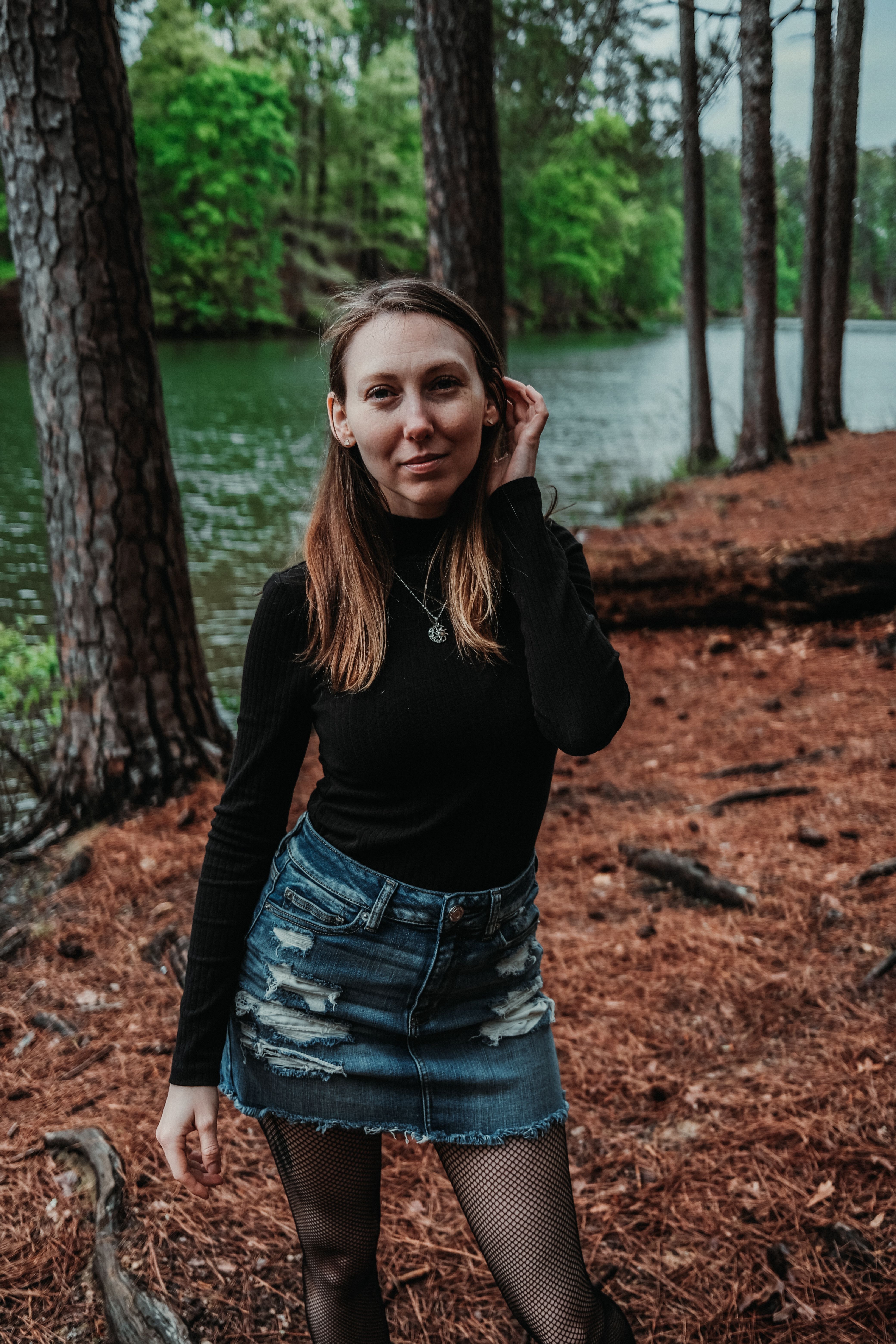 A Young Woman in a Denim Skirt Standing in a Forest · Free Stock Photo