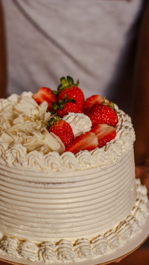 A white cake with strawberries on top