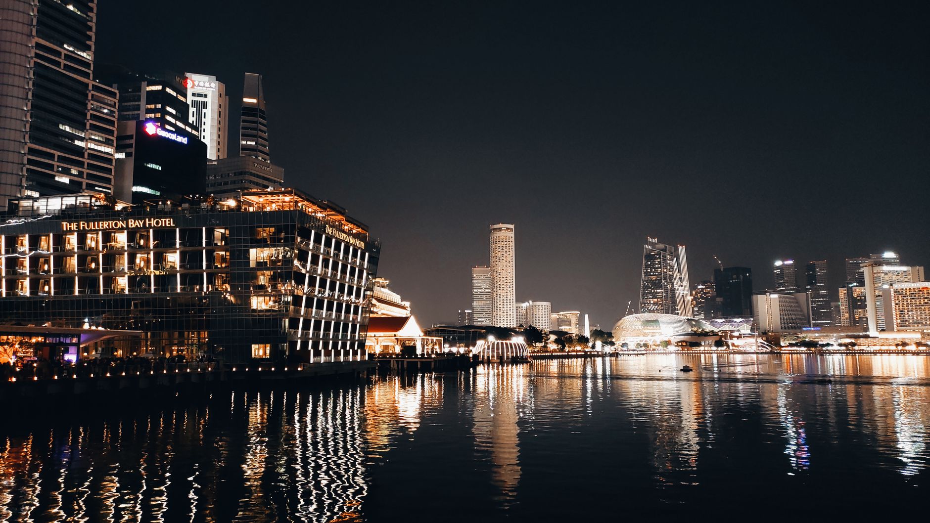Stunning nighttime cityscape of Marina Bay skyline in Singapore with illuminated buildings reflecting on waterfront. Related image for Market Trends: How Technology Is Reshaping Strategy.