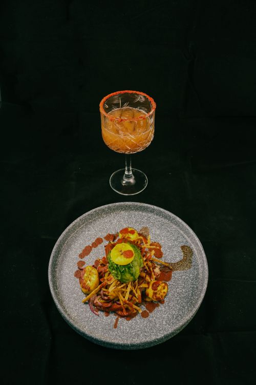 Free Elegant display of Mexican gourmet dish with a cocktail on a black backdrop. Perfect for food photography enthusiasts. Stock Photo