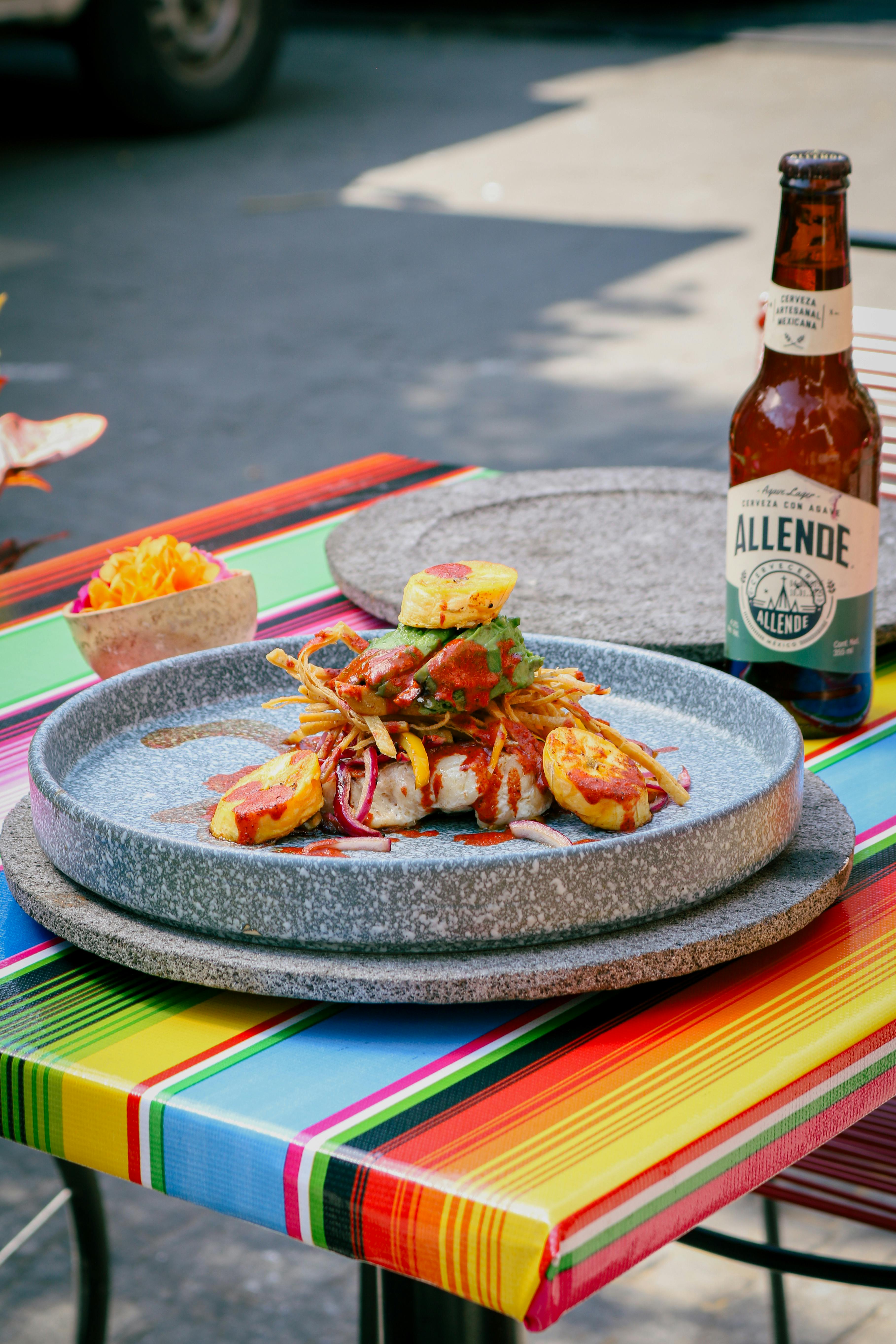 Vibrant Mexican dish with Allende beer on a colorful table in Ciudad de México.
