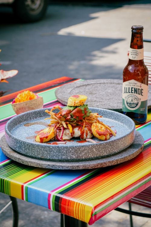 Free Vibrant Mexican dish with Allende beer on a colorful table in Ciudad de México. Stock Photo
