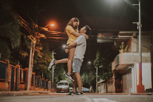 Man Lifting Woman On Road