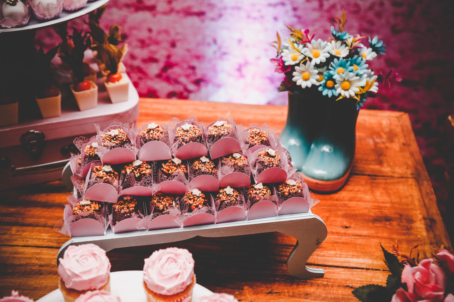 Beautifully arranged brownies on a dessert table with floral decor, perfect for special occasions.