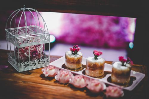 Free Artistic mini desserts garnished with flowers, ideal for weddings or special events. Stock Photo