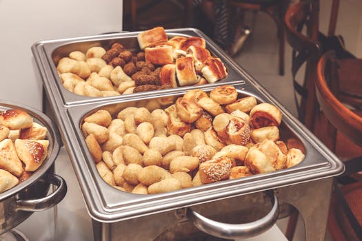 A variety of baked pastries displayed in a catering buffet tray, perfect for events.