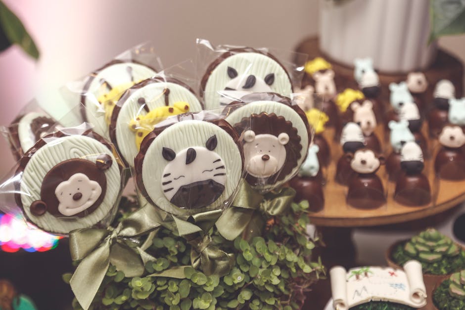 Cute chocolate lollipops with animal faces displayed elegantly for a party.