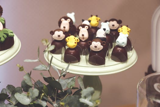 Delightful animal-themed chocolate desserts on a elegant display stand for a charming party setup.