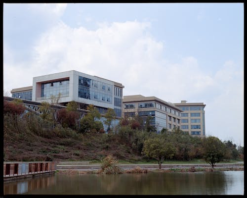 A large building with a lake in the background