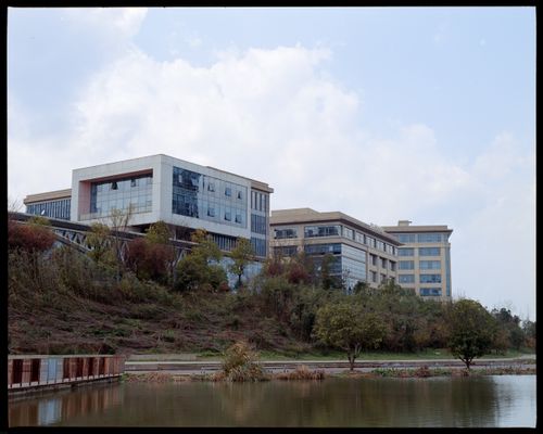 Free Contemporary buildings reflected in a tranquil lake setting during fall. Stock Photo