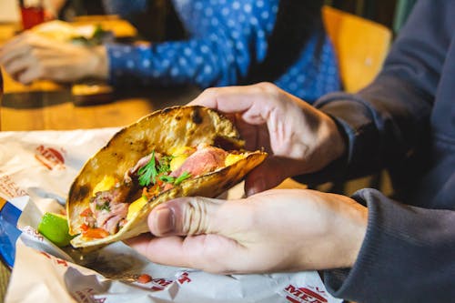 Free Person Showing Taco With Parsley On Top Stock Photo