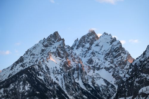 Free Breathtaking view of the snowcapped Teton Range under a clear blue sky in Wyoming, USA. Stock Photo