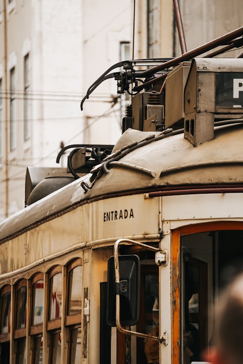 An old trolley car is parked in the city