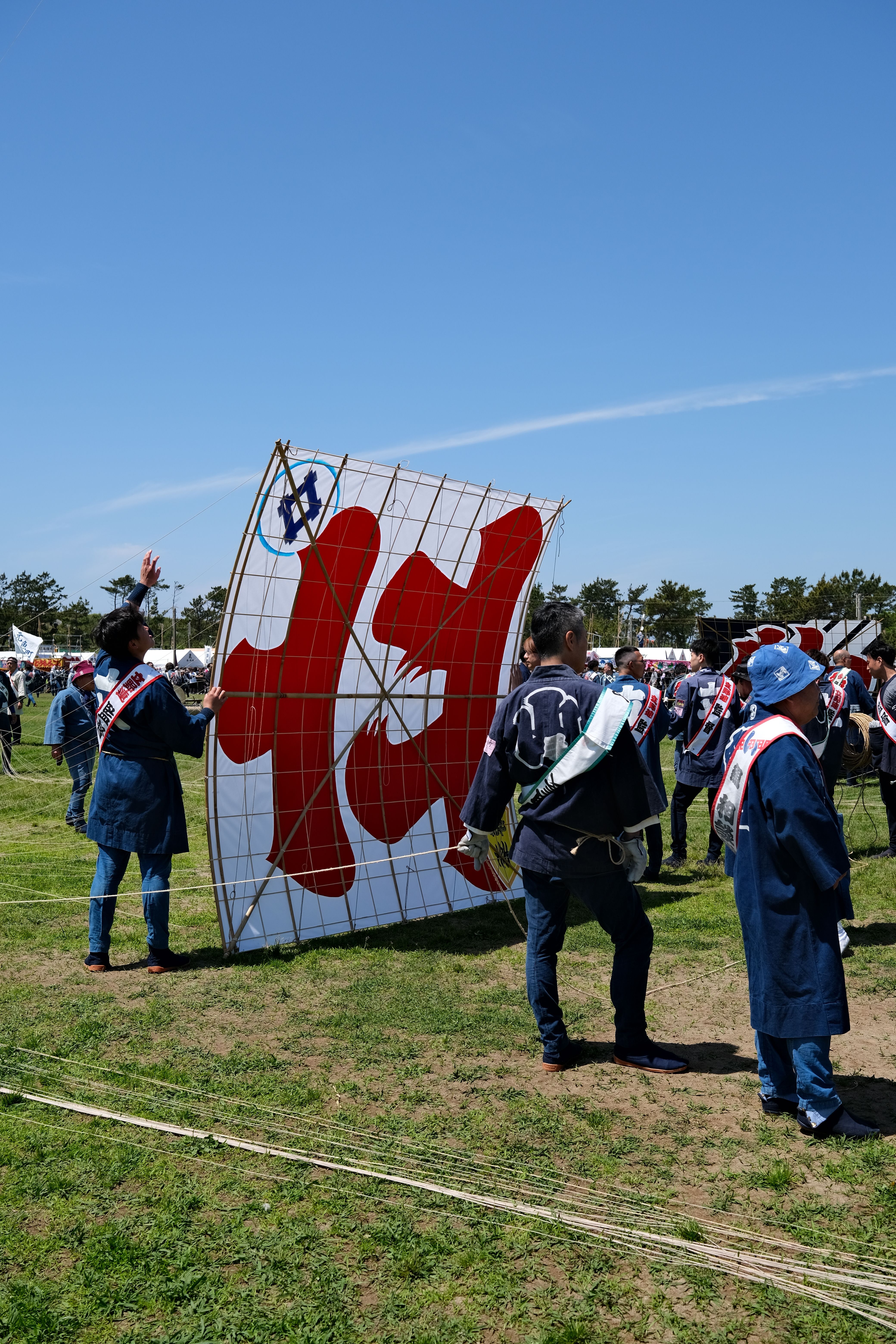 Men Preparing a Giant Kite for Flight at a Festival · Free Stock Photo