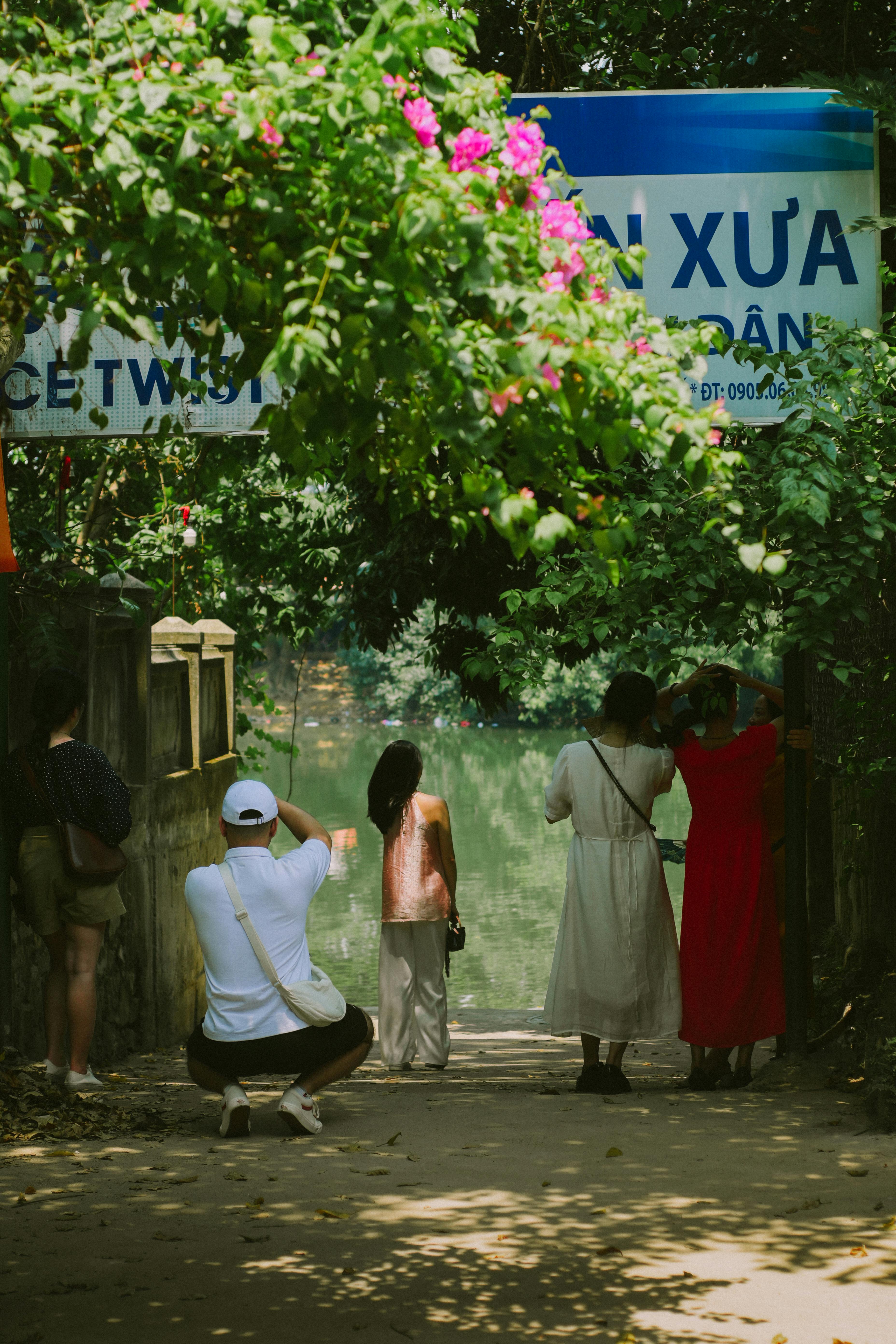 back view of people standing near a body of water