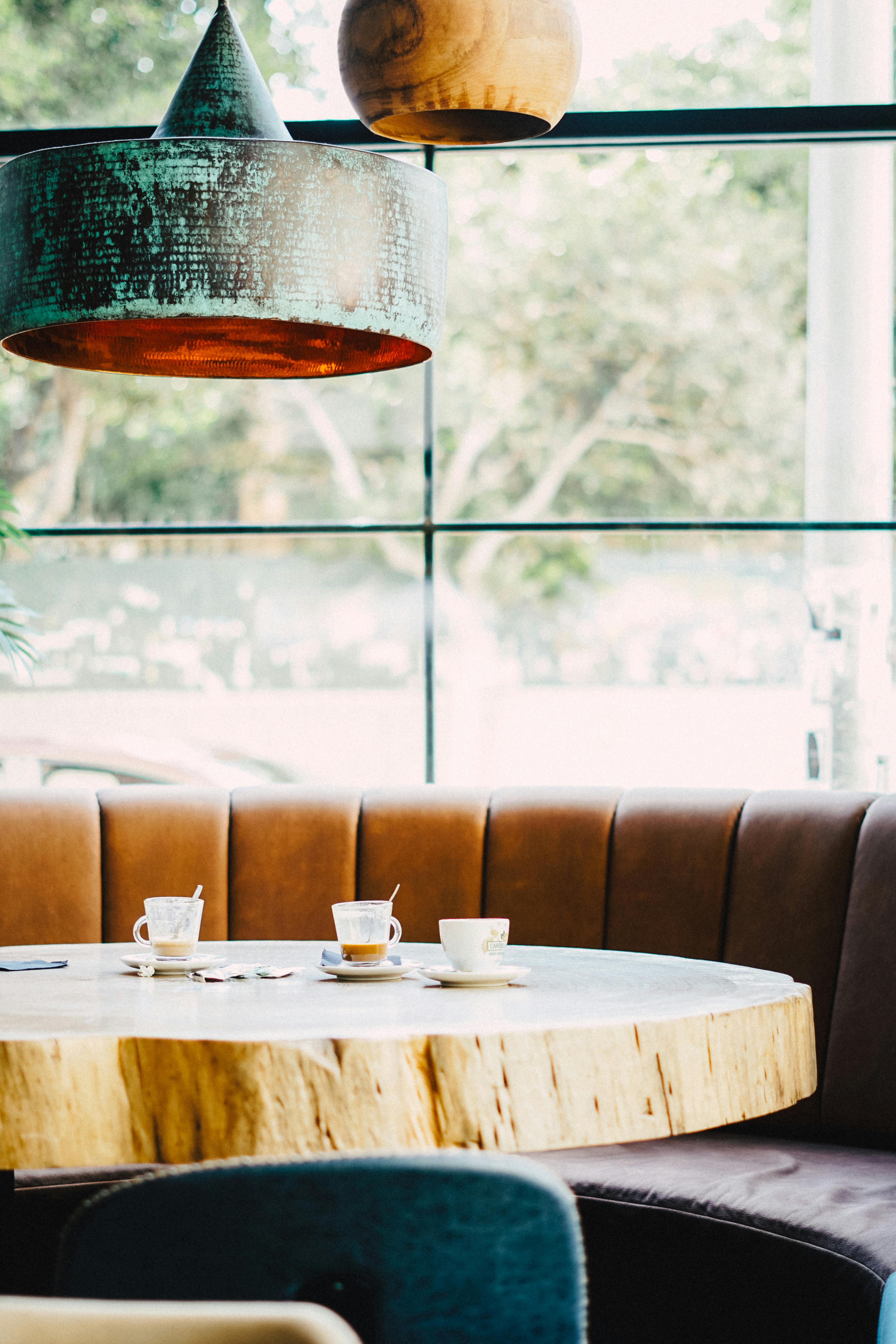 Warm café atmosphere featuring a rustic wooden table and comfortable seating, perfect for relaxation.