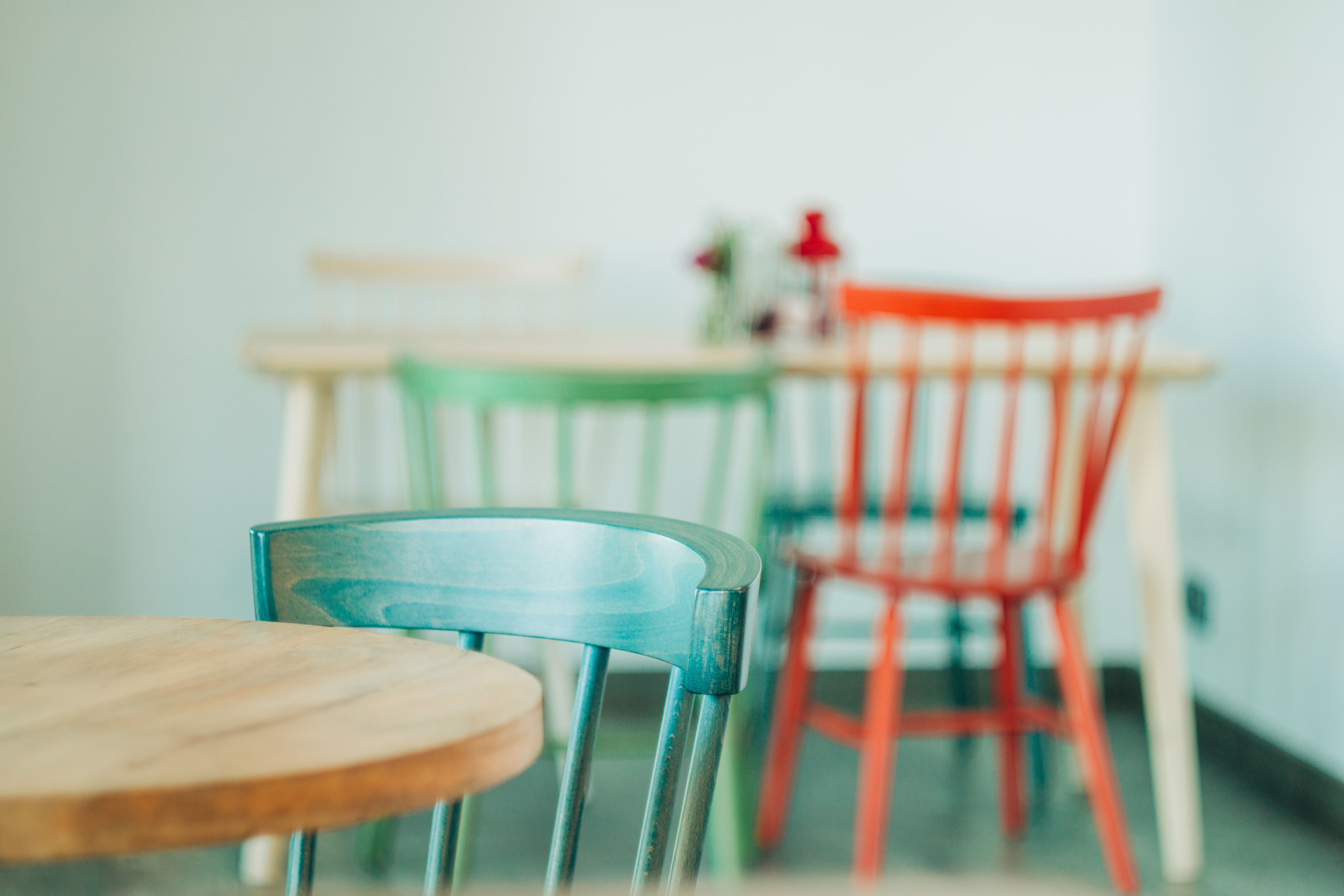 Stylish wooden chairs and table arrangement in a cozy indoor cafe setting
